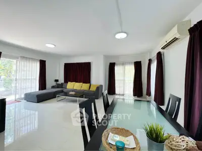 Spacious living room with modern decor and large windows for natural light.