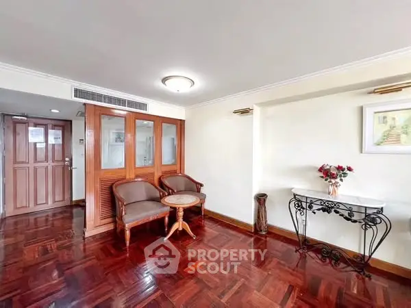Elegant entryway with wooden floors and classic furniture in a welcoming home.