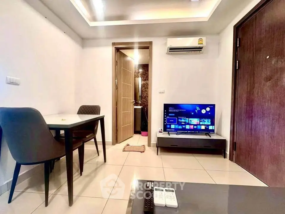 Modern living room with sleek furniture and wall-mounted TV, perfect for cozy urban living.