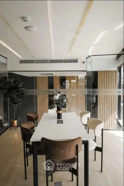 Modern study room with sleek glass walls and elegant furniture