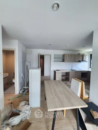 Modern open-layout kitchen and dining area with light wood finishes and ample natural light.