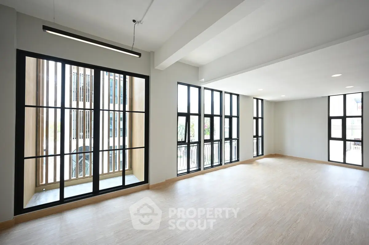 Spacious modern living room with large windows and natural light