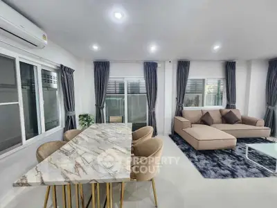 Modern living room with marble dining table and cozy seating area