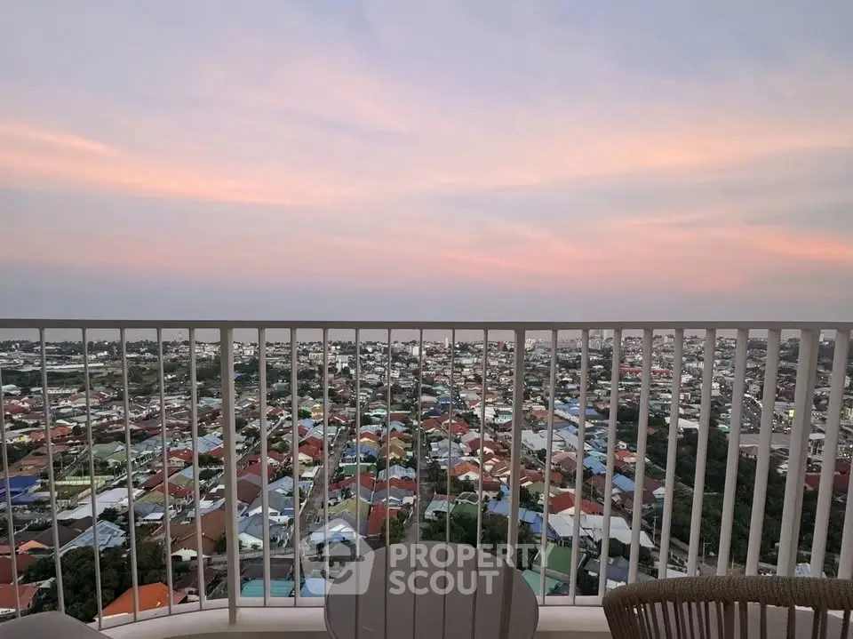 Stunning balcony view overlooking a vibrant cityscape at sunset, perfect for urban living enthusiasts.