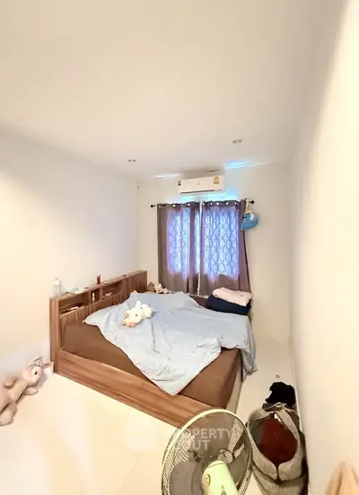 Cozy bedroom with soft lighting and plush decor, perfect for relaxation and comfort.