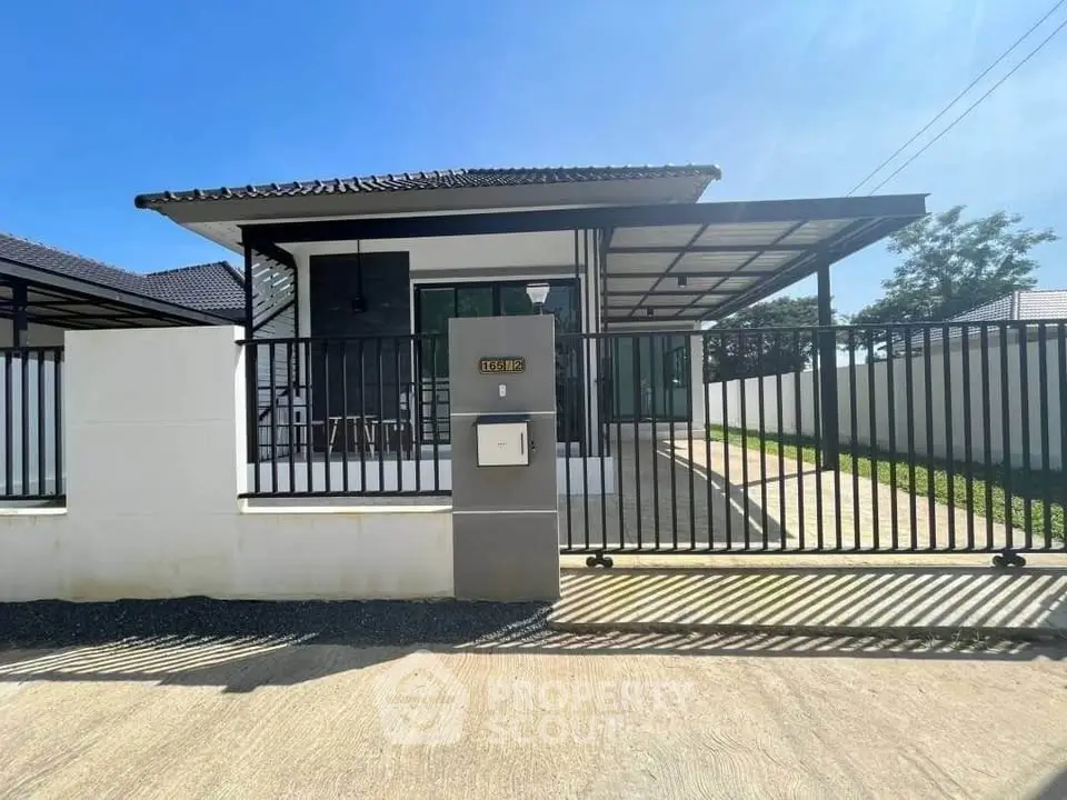 Charming single-story house with modern design and spacious driveway in a serene neighborhood.