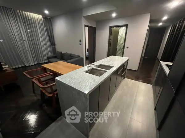Modern open-layout kitchen with sleek design and cozy living area.