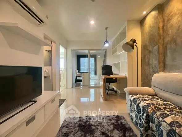 Modern living room with sleek design, featuring a cozy sofa, TV, and a stylish study area with ample shelving.