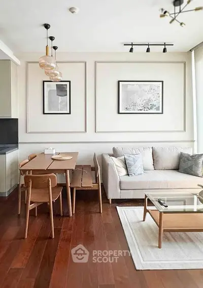 Modern living room with stylish decor, wooden flooring, and cozy seating area.
