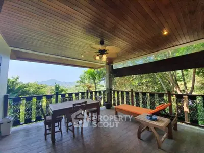 Spacious outdoor balcony with stunning mountain views and cozy seating area.