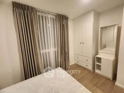 Cozy bedroom with elegant curtains and modern wardrobe in a stylish apartment.