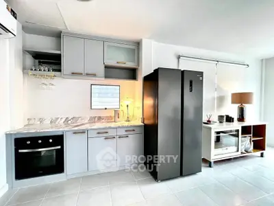 Modern kitchen with sleek appliances and stylish cabinetry in a bright, open space.