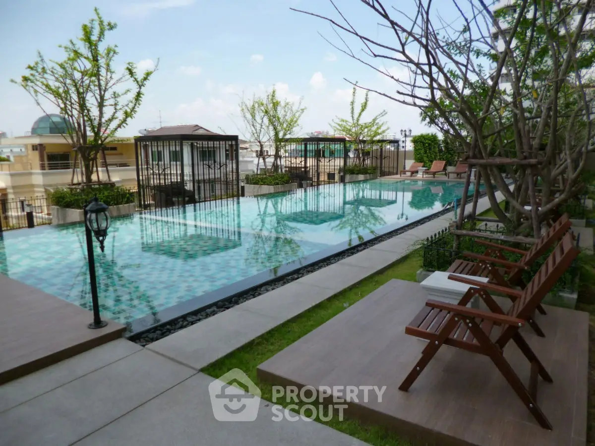 Luxurious outdoor pool area with elegant seating and lush greenery