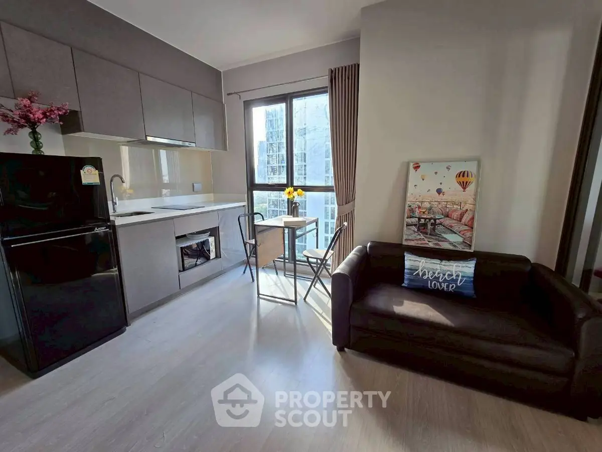 Modern kitchen and living area with sleek design and natural light