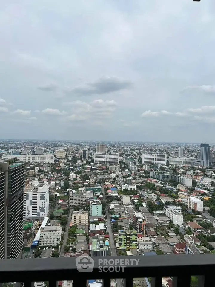 Stunning cityscape view from high-rise balcony showcasing urban skyline and expansive horizon.