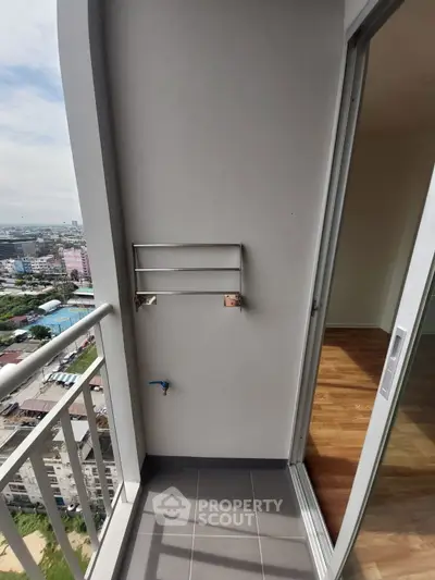 Modern balcony with city view and sliding door access to interior space.
