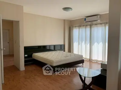 Spacious bedroom with modern furnishings and natural light