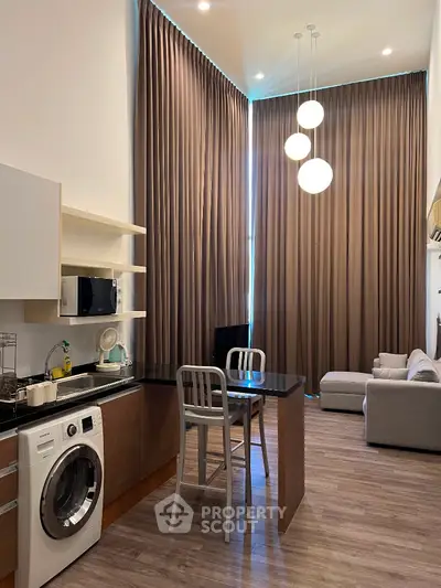Modern apartment interior with high ceilings, open kitchen, and stylish living area