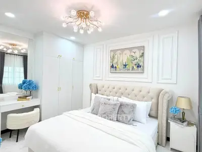Luxurious bedroom with elegant decor and plush bedding in a modern apartment.