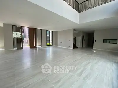 Spacious modern living room with high ceilings and large windows