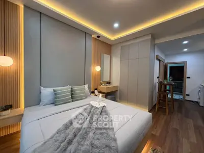 Modern bedroom with stylish lighting and cozy decor in a contemporary apartment.