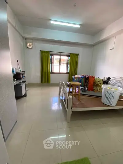 Spacious bedroom with natural light and minimalist decor, ideal for cozy living.