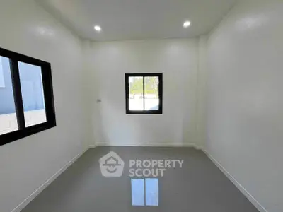 Minimalist empty room with large windows and glossy tiled floor