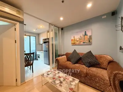 Cozy living room with plush sofa and modern kitchen view