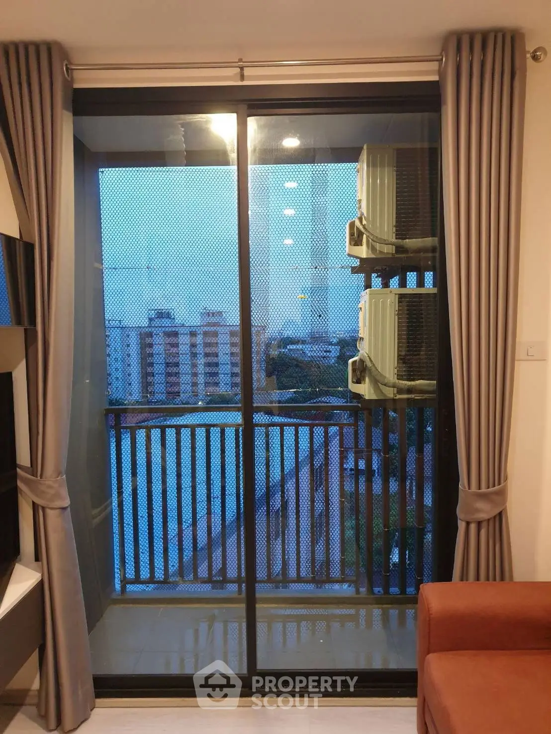 Modern apartment balcony with city view and air conditioning units