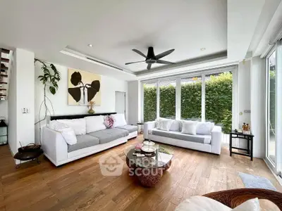 Spacious modern living room with large windows and stylish decor