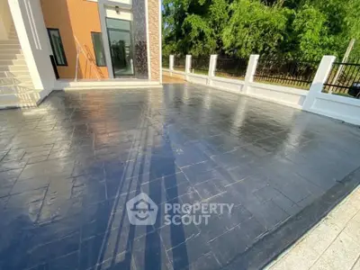Spacious modern driveway with sleek black tiles and elegant entrance
