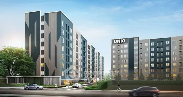 Modern apartment complex with sleek design and lush surroundings, ideal for urban living.