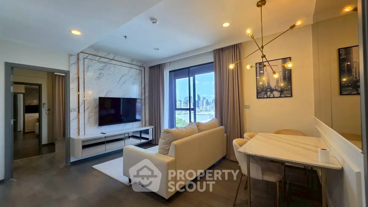 Modern living room with city view, elegant decor, and stylish lighting in a high-rise apartment.