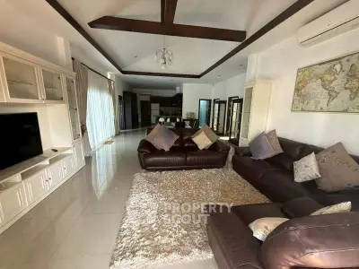 Spacious living room with leather sofas and modern decor in a luxurious home.