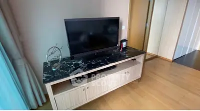 Modern living room with sleek TV stand and marble top, showcasing elegant interior design.