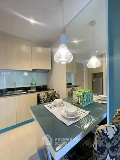 Modern kitchen with dining area, sleek cabinetry, and stylish lighting.