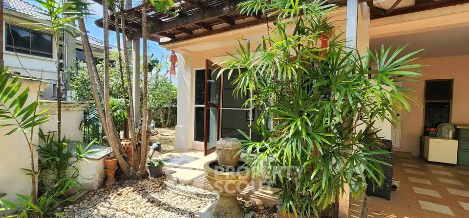 Charming garden view with lush greenery and elegant water feature in a serene residential setting.