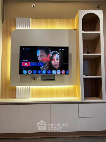 Modern living room with built-in entertainment center and ambient lighting