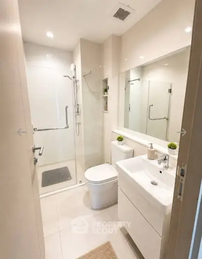 Modern bathroom with sleek fixtures and glass shower enclosure