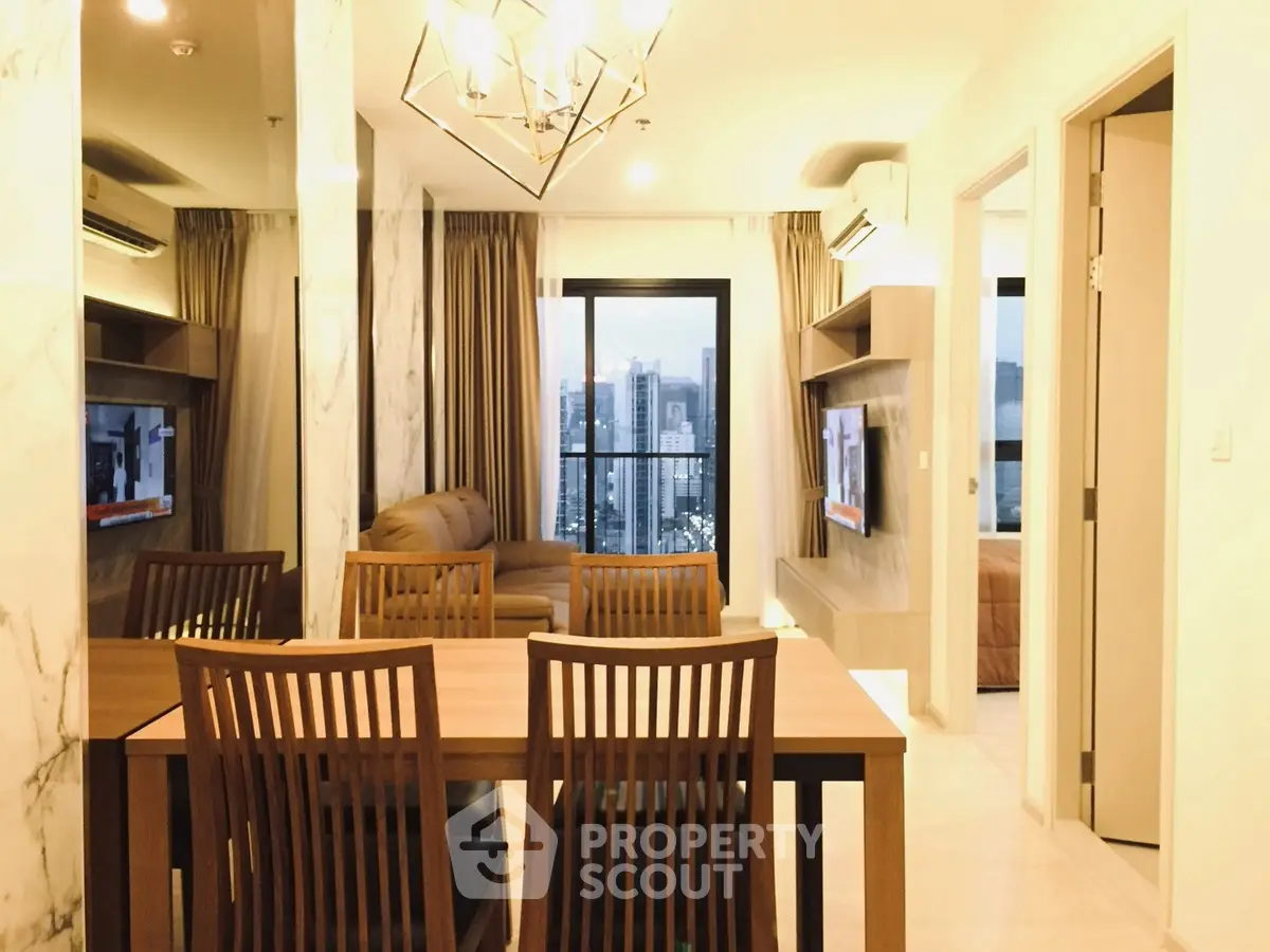 Modern living room with city view, elegant dining area, and stylish lighting in a high-rise apartment.