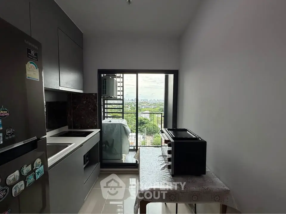 Modern kitchen with balcony view, sleek cabinetry, and natural light, perfect for urban living.
