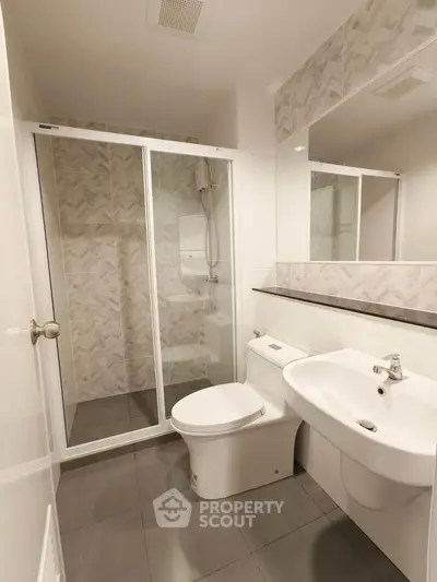 Modern bathroom with sleek shower enclosure and elegant fixtures