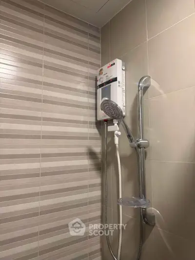 Modern bathroom with sleek shower unit and stylish tile design, perfect for contemporary living.