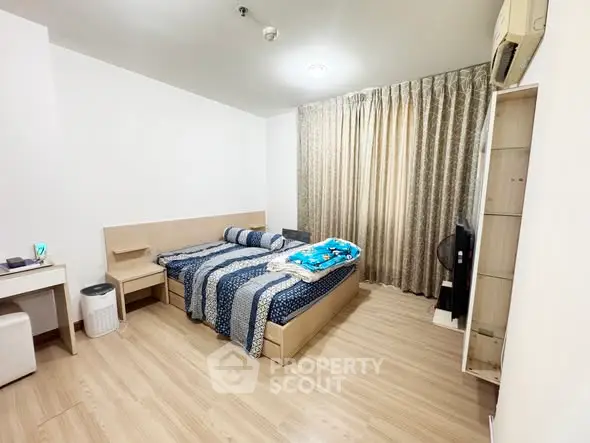 Spacious bedroom with modern decor and natural light