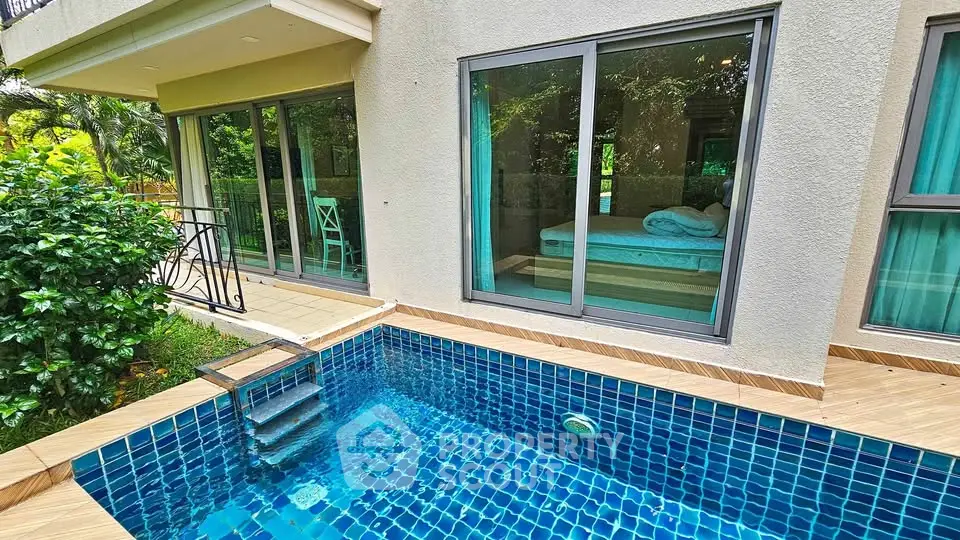 Luxurious poolside view with modern architecture and lush greenery