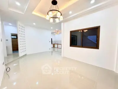 Spacious modern living room with elegant lighting and glossy tiled floors, perfect for stylish living.