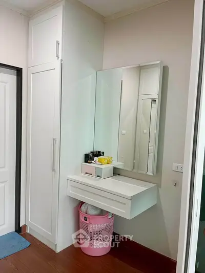 Modern bedroom with built-in wardrobe and stylish vanity area