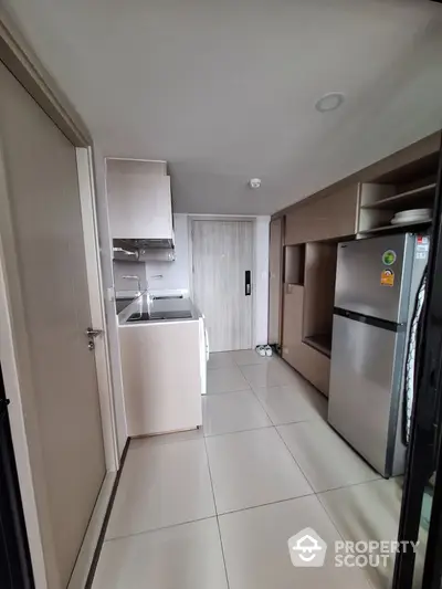 Modern kitchen with sleek cabinetry and stainless steel appliances in a compact layout.