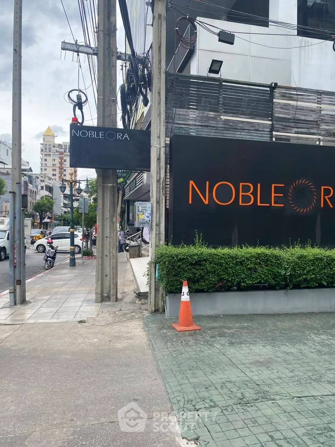 Modern urban building exterior with prominent signage and street view.
