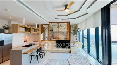 Luxurious modern living room with panoramic city views and stylish open kitchen design.